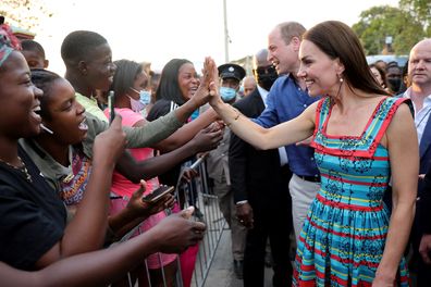 Prince William, Duke of Cambridge and Catherine, Duchess of Cambridge shake hands with people during a visit to Trench Town, the birthplace of reggae music, on day four of the Platinum Jubilee Royal Tour of the Caribbean on March 22, 2022 in Kingston, Jamaica.  