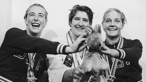 Dawn Fraser wins gold at the 1964 Tokyo Olympics, pictured with silver medallist Sharon Stouder of the US and bronze medallist Kathleen Ellis. (Source: Getty)