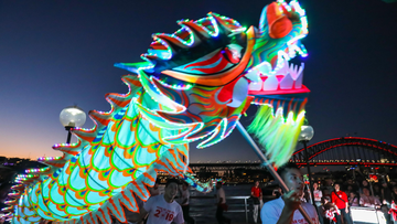 Circular Quay, Sydney - 9th February 2019. City of Sydney present Sydney Lunar Festival. People enjoy an LED lion and dragon performance in front of the monkey lantern.