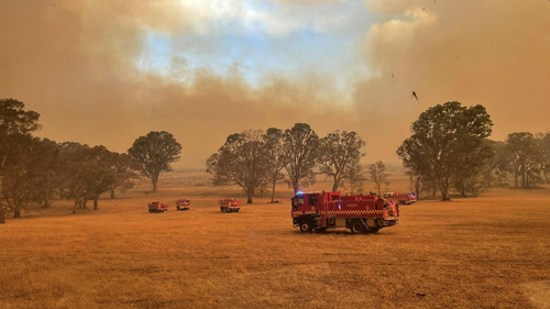 A fire truck in front of bushfires burning in Grampians National Park, December 23, 2024.