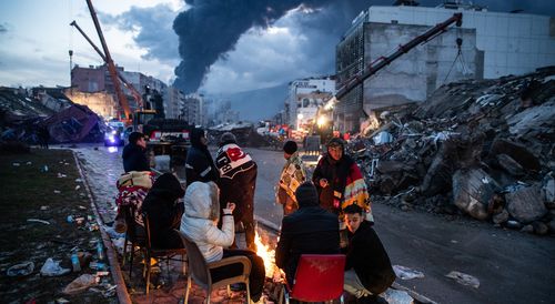 People try to rescue their loved ones, believed to be trapped under collapsed building in Iskenderun, Turkey. 