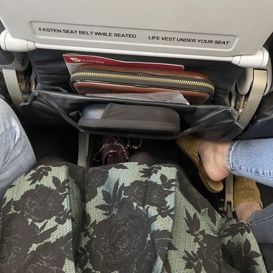 plane passenger reddit post: My Syd to Mel flight just now.  She pushed my arm off the armrest and plopped her feet in my space.  The middle seat already sucks enough.