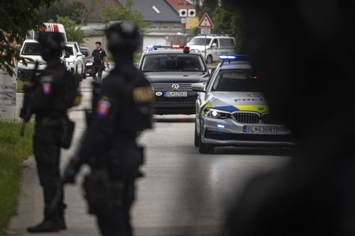 Policemen guard the area as convoy brings the suspect, in shooting of Slovakia's Prime Minister Robert Fico, to court in Pezinok, Slovakia, Saturday, May 18, 2024.