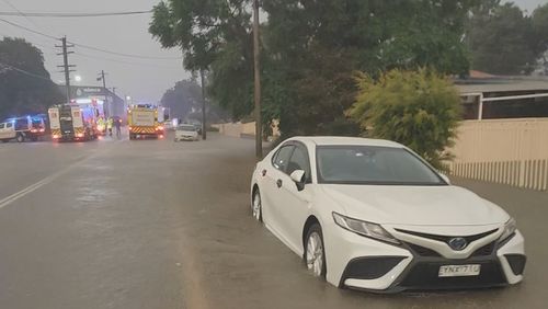 A man in his 60s is in hospital after he fell two metres down a flooded stormwater drain as persistent rain sparks flooding in parts of Sydney.