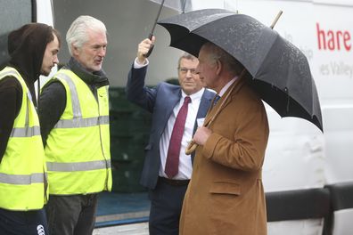 King Charles III, right meets staff members as he arrives withQueen Camilla to visit FareShare to launch the Coronation Food Project, on his birthday, in Didcot, England, Tuesday, Nov. 14, 2023