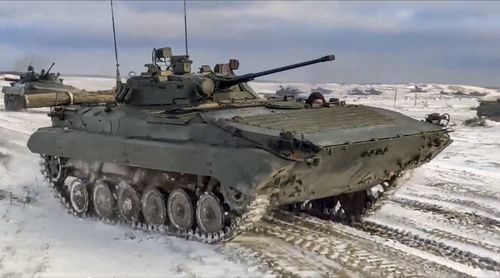 In this photo taken from video and released by the Russian Defense Ministry Press Service on Wednesday, Feb. 2, 2022, Russian and Belarusian armored vehicles drive during a joint military drills at Brestsky firing range, Belarus.  