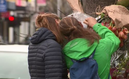 The family read tribute messages left on a pole near where Gitta died. 