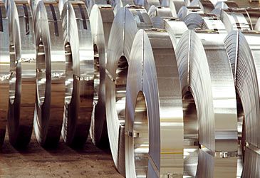 Ninety percent of steel is produced as an alloy of iron and what other element?