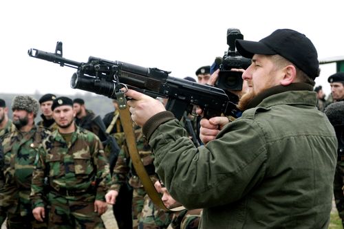 Ramzan Kadyrov proudly displays his shooting skills at a firing range in his village of Tsentoroi in front of members of his private army