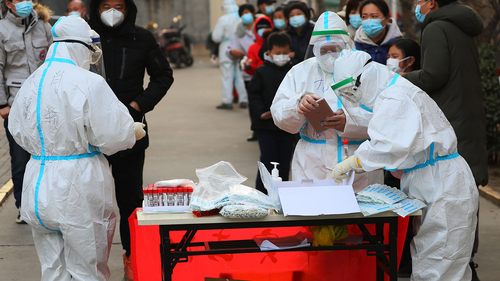 Citizens line up for the third round of testing in Shijiazhuang on January 18.