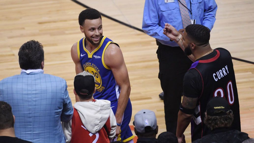 Drake and Steph Curry exchange words.