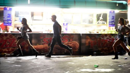 People are shown running from the concert. (Getty Images)