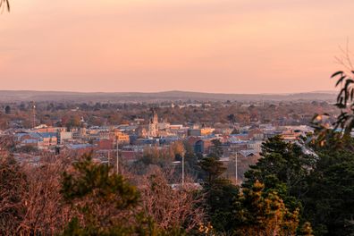 Ballarat, Victoria, Australia - May, 23 2021: Brilliant pinks in the sky above the regional Victorian mining city of Ballarat as the sunsets off in the distance as seen from Black Hill lookout.