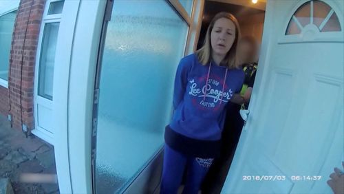 A view of Lucy Letby, who was on trial at Manchester Crown Court charged with the murder of seven babies, being taken in custody by police, in Chester, Britain, in this screengrab obtained from an undated Handout video obtained by Reuters on August 17, 2023.  