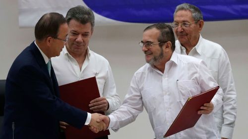 Commander of the Revolutionary Armed Forces of Colombia or FARC, Rodrigo Londono, better known as Timochenko or Timoleon Jimenez, second right, shakes hands with U.N. Secretary General Ban Ki-moon. (AAP)