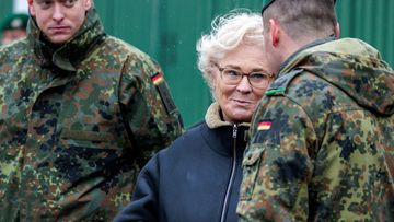 German Defence Minister Christine Lambrecht speaks with members of a German infantry unit.