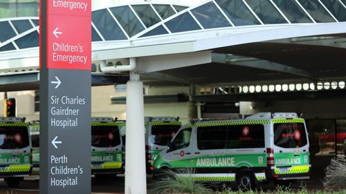Ambulances parked outside the Sir Charles Gairdner Hospital in Perth where a man has died from coronavirus.