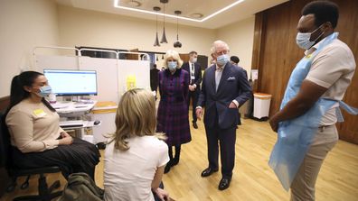 Britain's Prince Charles and Camilla, Duchess of Cornwall talk with staff during a visit to the Queen Elizabeth Hospital in Birmingham, England, Wednesday Feb. 17, 2021, to thank volunteers undertaking clinical trials for the COVID-19 vaccinations.