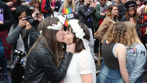 Jane and Josie take part in a mock wedding during a marriage equality rally in Melbourne, Saturday, August 26, 2017.