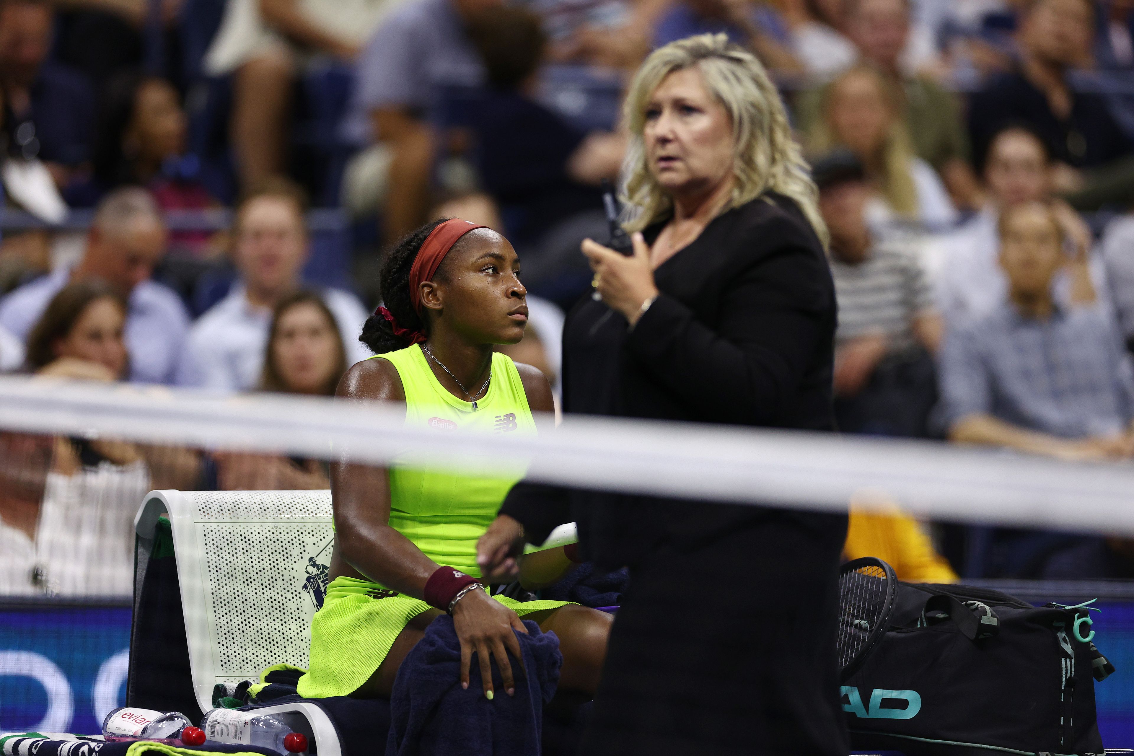 An official speaks to Coco Gauff during the break in play.