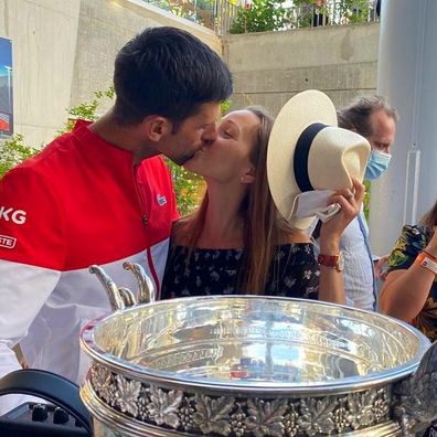 Novak and Jelena Djokovic share a kiss after year another big win for the tennis champ.