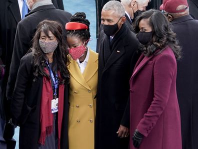 Amanda Gorman, center, takes a photo with former president Barack Obama and Michelle Obama prior to the 59th Presidential Inauguration 