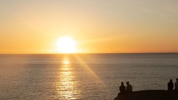 People watch the sunrise at Mackenzie&#x27;s Point, Bondi.