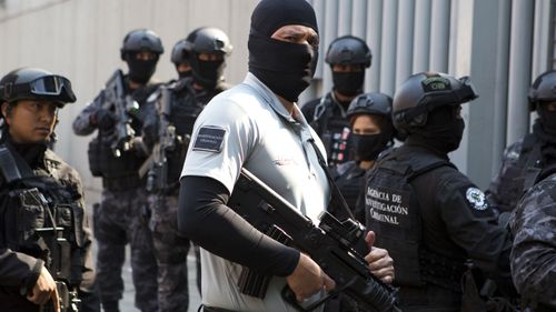 Security agents guard a gate to the attorney general's office for organised crime as a convoy arrives carrying Damaso Lopez, nicknamed "El Licenciado," in Mexico City last year. Mexican prosecutors said they captured Lopez, one of the Sinaloa cartel leaders who launched a struggle for control of the gang following the re-arrest of Joaquin "El Chapo" Guzman. Lopez was long considered Guzman's right-hand man and helped him escape from a Mexican prison in 2001.