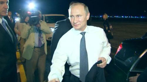 Russian President Vladimir Putin shakes hands with the G20 welcoming party. (9NEWS)