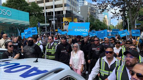 Brian and Hannah Tamaki march down Queen St followed by supporters.