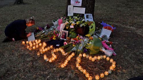 A member of the public signs a condolence book at a makeshift memorial at the Al Noor Mosque on Deans Rd in Christchurch, New Zealand.