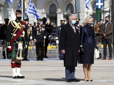 Prince Charles, front left, and his wife Camilla, the Duchess of Cornwall arrive to lay a wreath at the tomb of the Unknown Soldier in Athens, Thursday, March 25, 2021.