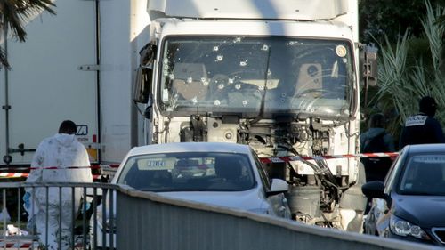 Investigators examine the bullet-riddled truck on the morning after it was used in a terror attack in Nice. (Getty)