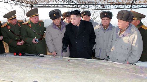 Kim Jong-un surveys a map surrounded by his generals. (KCNA)