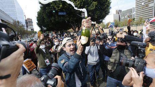 People celebrate the victory of President-elect Joe Biden and Vice President-elect Kamala Harris in Los Angeles.