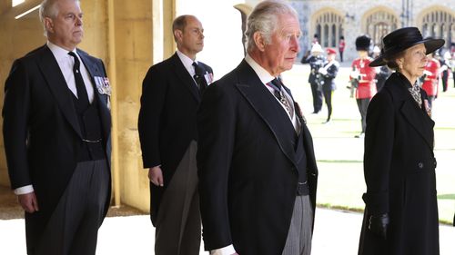 From left, Prince Andrew, Prince Edward, Prince Charles and Princess Anne arrive after walking in a procession behind the coffin of Prince Philip, with other members of the Royal family during the funeral of Britain's Prince Philip inside Windsor Castle in Windsor, England, Saturday, April 17, 2021. Prince Philip died April 9 at the age of 99 after 73 years of marriage to Britain's Queen Elizabeth II.