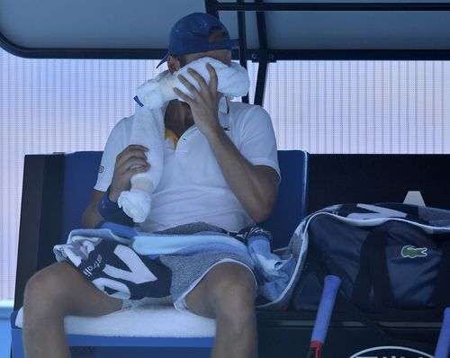 United States' Denis Kudla uses a cool towel during a break while playing Austria's Dominic Thiem during their second round match. (AAP)