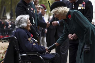 Camilla, the Queen Consort greets a military veteran as she attend the 94th Field of Remembrance service at Westminster Abbey in London, Thursday, Nov. 10, 2022 
