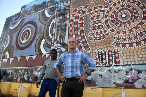 Mr Turnbull is shown a community mural by traditional owner Ronald Plummer in Tennant Creek. Picture: AAP