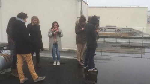 French journalists shelter on roof as gunmen storm office