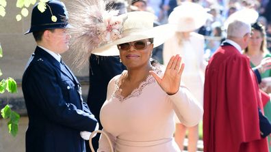 Oprah Winfrey waves as she arrives at St George's Chapel at Windsor Castle the wedding ceremony of Prince Harry and Meghan Markle at St. George's Chapel in Windsor Castle in Windsor, near London, England, Saturday, May 19, 2018.