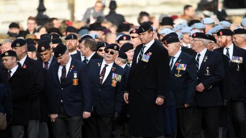 Britain's war veterans march down Whitehall during the Remembrance Sunday service in London, Britain. (AAP)