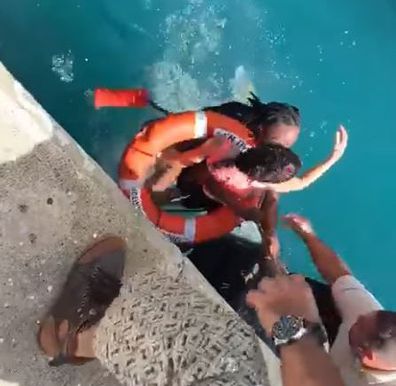 The two Department Of Tourism workers bravely dived into the water to save the young woman