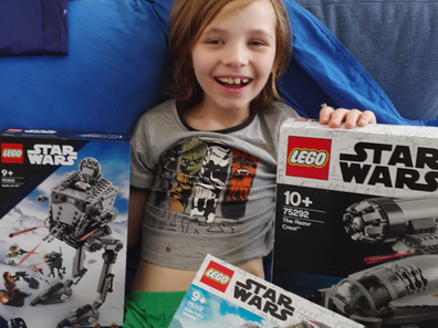Rebecca's son, Oscar, with his Star Wars gifts a stranger sent after learning about the family losing everything during the Lismore floods.