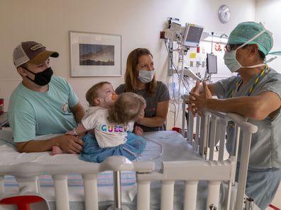 Conjoined twins at home after being separated in surgery.