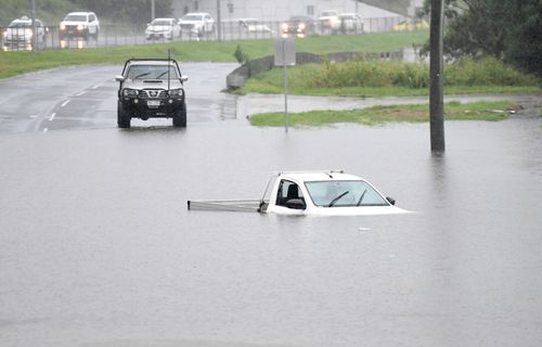 A vehicle is submerged by flood waters on February 26, 2022 in the suburb of Oxley in Brisbane, Australia.