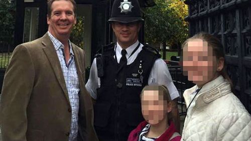 An unknown family pose with PC Keith Palmer.