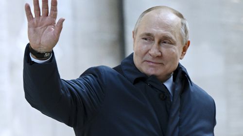 Russian President Vladimir Putin gestures as he leaves after visiting the construction site of the National Space Agency in Moscow, Russia.