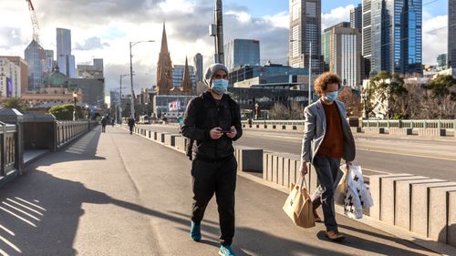 Pedestrians walk away from the central business district in Melbourne.