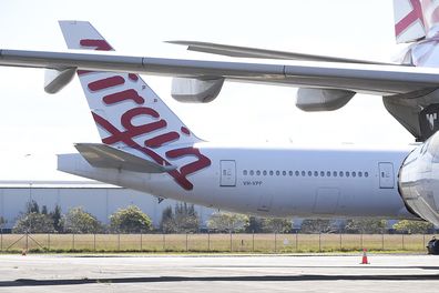 BRISBANE, AUSTRALIA - AUGUST 05: Virgin Australia wide-body aircrafts are seen parked in the Brisbane Airport on August 05, 2020 in Brisbane, Australia. Virgin Australia has announced 3000 job cuts as part of a radical cost reduction strategy for the airline, while its discount provider Tiger Air will close. (Photo by Albert Perez/Getty Images)